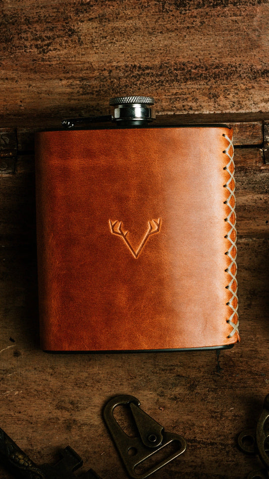 Hand-stitched leather flask on a workbench in the MUSS leather studio, Las Vegas