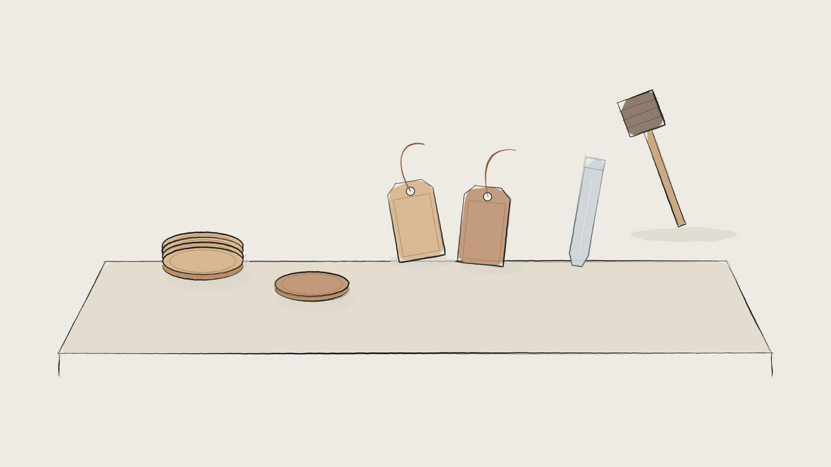 Ink sketch of an event table with leather coasters, tags, a stamp and a mallet