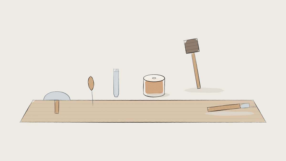 Ink sketch of a single workbench with knife, awl, stamp, thread, mallet and pricking iron